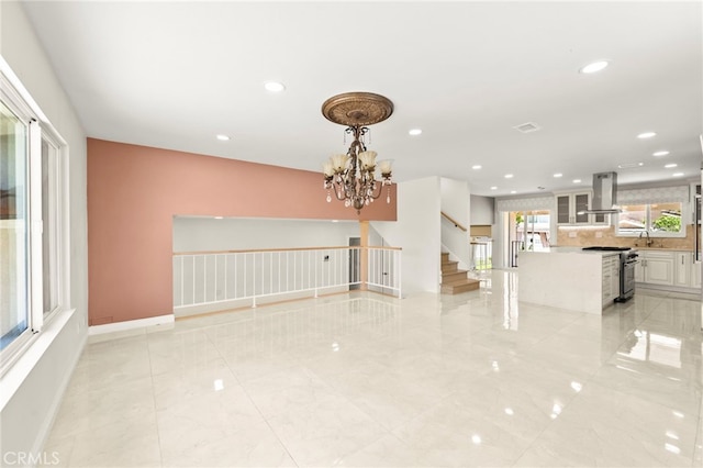 241 S Solomon Dr, Anaheim, CA 92807 - unfurnished living room featuring stairs, a chandelier, recessed lighting, and baseboards