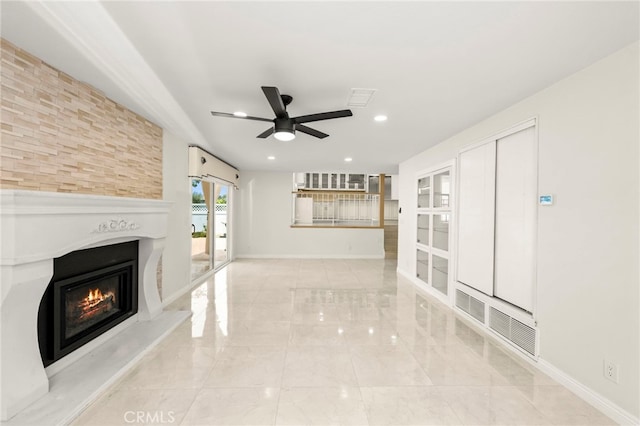 241 S Solomon Dr, Anaheim, CA 92807 - unfurnished living room featuring a ceiling fan, a glass covered fireplace, recessed lighting, marble finish floors, and baseboards