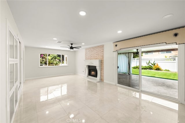 241 S Solomon Dr, Anaheim, CA 92807 - unfurnished living room featuring a ceiling fan, light tile patterned floors, recessed lighting, baseboards, and a large fireplace