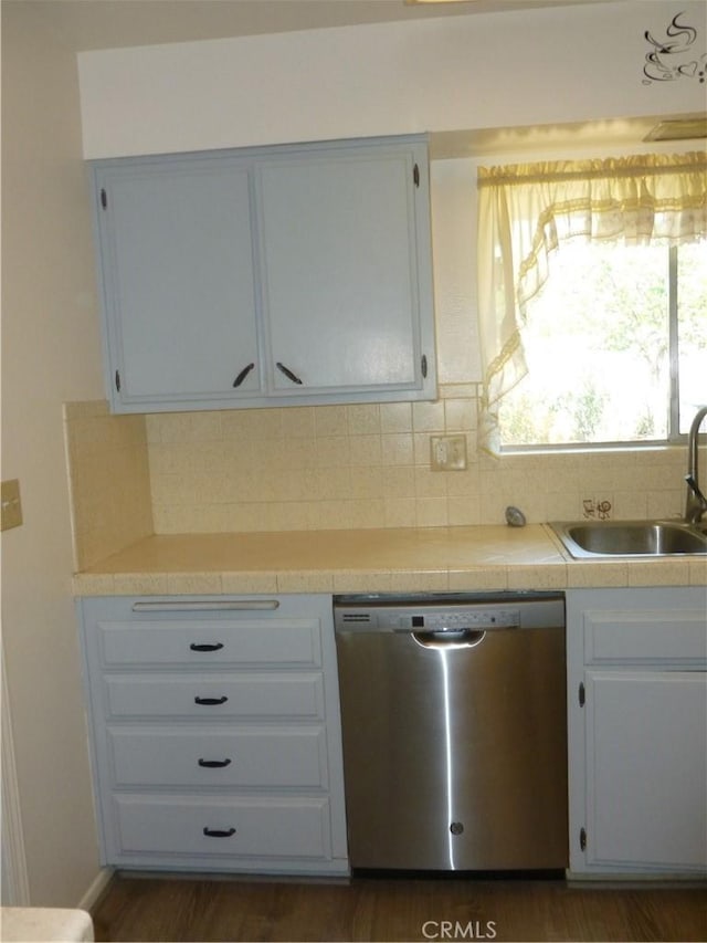 26276 Foxgrove Rd, Menifee, CA 92586 - kitchen featuring dishwasher, a sink, white cabinetry, and tasteful backsplash