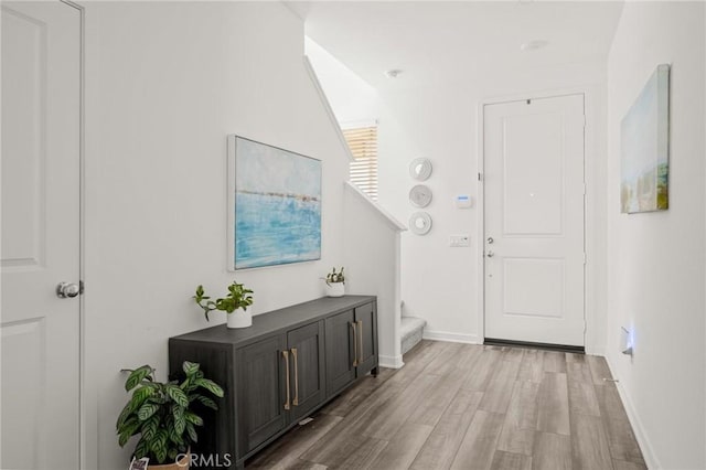 1924 N Floret Dr, Los Angeles, CA 90222 - foyer entrance featuring stairs, light wood-style floors, and baseboards