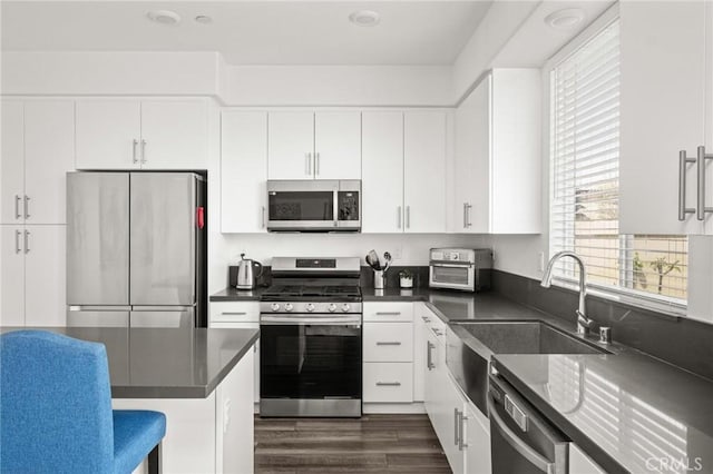 1924 N Floret Dr, Los Angeles, CA 90222 - kitchen with appliances with stainless steel finishes, dark countertops, and healthy amount of natural light