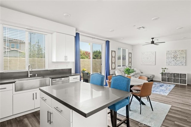 1924 N Floret Dr, Los Angeles, CA 90222 - kitchen with a sink, dark countertops, dark wood-style flooring, white cabinets, and ceiling fan