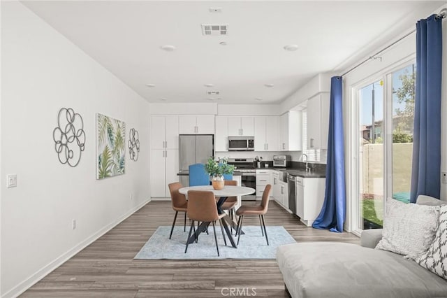 1924 N Floret Dr, Los Angeles, CA 90222 - dining area featuring wood finished floors and baseboards