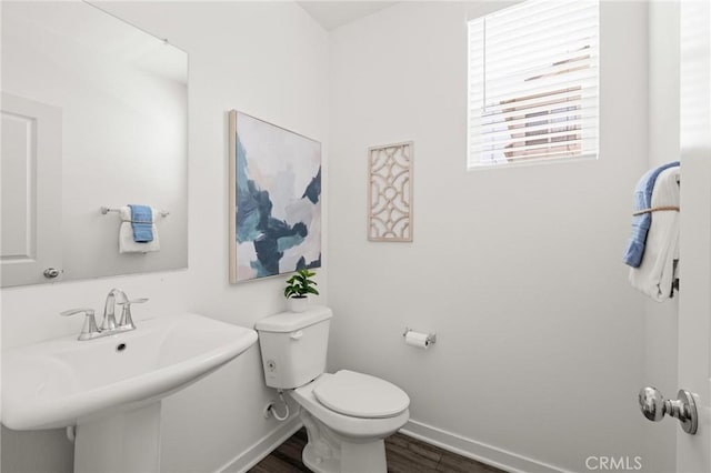 1924 N Floret Dr, Los Angeles, CA 90222 - half bath featuring baseboards, toilet, wood finished floors, and a sink