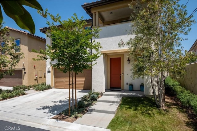 1924 N Floret Dr, Los Angeles, CA 90222 - view of front of house featuring stucco siding, driveway, and a garage
