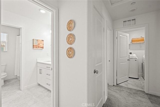 1924 N Floret Dr, Los Angeles, CA 90222 - hallway featuring washing machine and clothes dryer and baseboards
