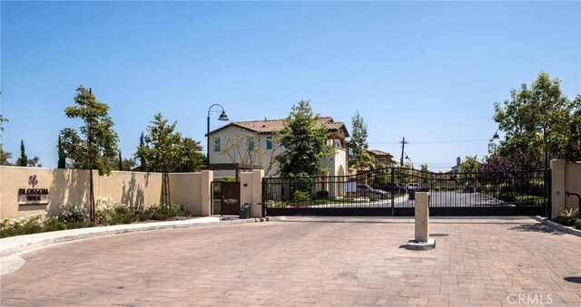 1924 N Floret Dr, Los Angeles, CA 90222 - view of decorative road featuring a gate, curbs, and a gated entry