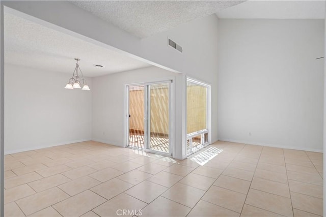 44114 30th St W, Lancaster, CA 93536 - unfurnished room featuring a chandelier, light tile patterned floors, a textured ceiling, and baseboards