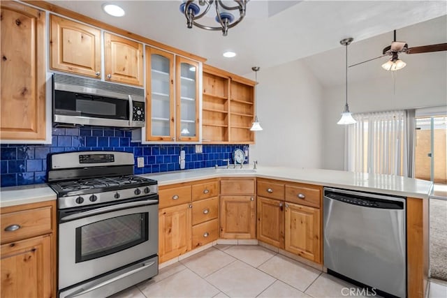 44114 30th St W, Lancaster, CA 93536 - kitchen with stainless steel appliances, a peninsula, open shelves, tasteful backsplash, and light tile patterned floors