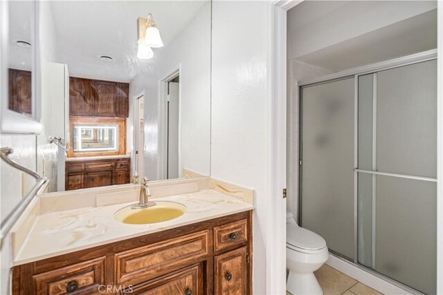 44114 30th St W, Lancaster, CA 93536 - full bath featuring vanity, toilet, a stall shower, and tile patterned flooring