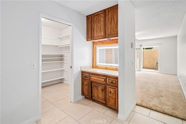 44114 30th St W, Lancaster, CA 93536 - bar area featuring light tile patterned flooring, baseboards, and light carpet