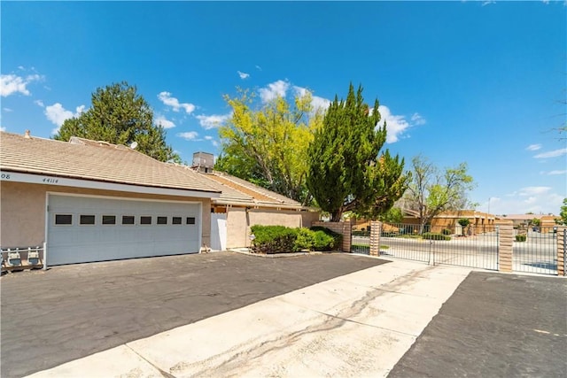 44114 30th St W, Lancaster, CA 93536 - view of front of property featuring stucco siding, a gate, and a tile roof