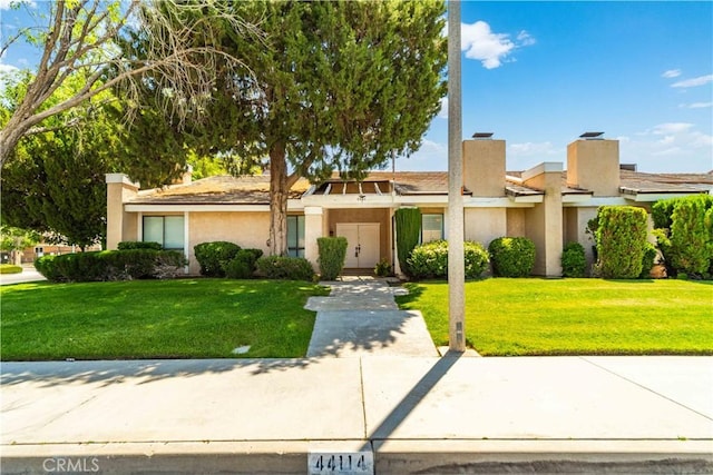 44114 30th St W, Lancaster, CA 93536 - view of front of house with stucco siding and a front lawn