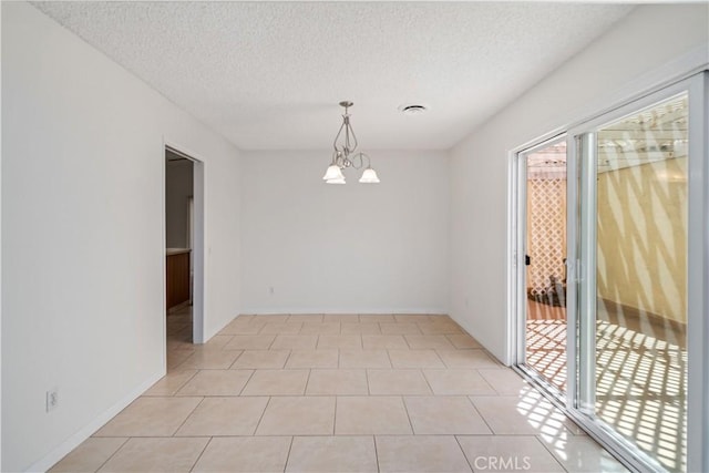 44114 30th St W, Lancaster, CA 93536 - empty room with healthy amount of natural light, a textured ceiling, a chandelier, light tile patterned floors, and baseboards