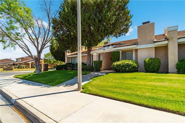 44114 30th St W, Lancaster, CA 93536 - view of front facade featuring a front lawn, stucco siding, and a chimney