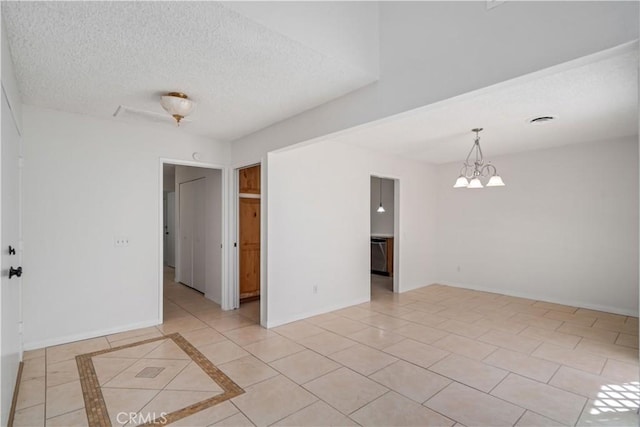 44114 30th St W, Lancaster, CA 93536 - unfurnished room with a textured ceiling, a chandelier, baseboards, and light tile patterned floors