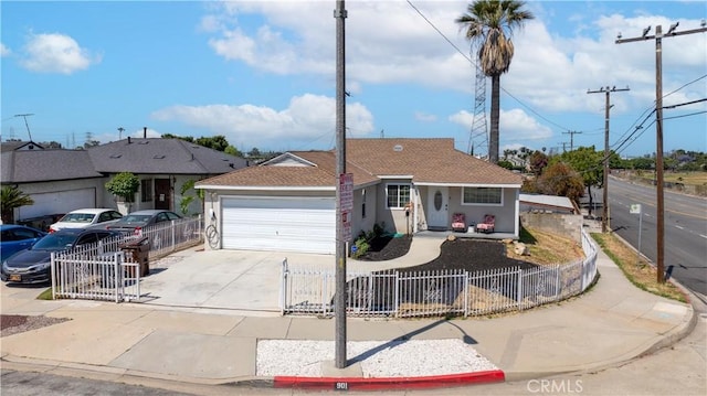 901 S Clymar Ave, Compton, CA 90220 - ranch-style home featuring a fenced front yard, concrete driveway, a garage, stucco siding, and roof with shingles