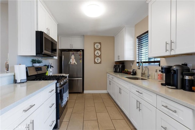 901 S Clymar Ave, Compton, CA 90220 - kitchen featuring stainless steel appliances, a sink, white cabinetry, and light tile patterned floors