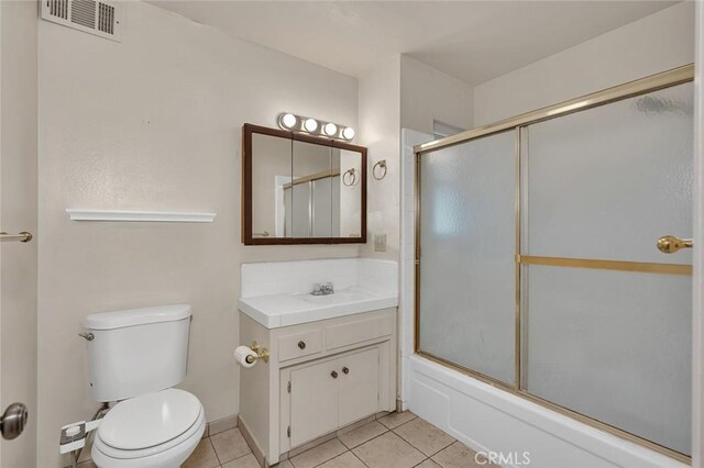 635 Brookdale Dr, Merced, CA 95340 - bathroom with vanity, tile patterned floors, toilet, and enclosed tub / shower combo