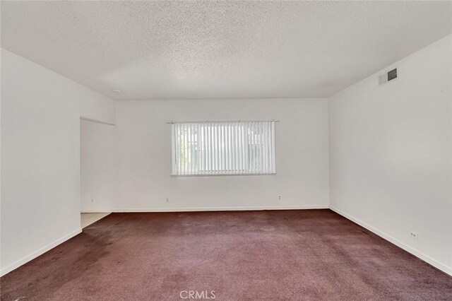 635 Brookdale Dr, Merced, CA 95340 - carpeted spare room with a textured ceiling and baseboards