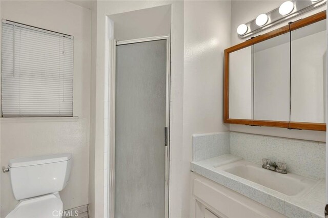 635 Brookdale Dr, Merced, CA 95340 - full bathroom featuring a stall shower, toilet, and vanity