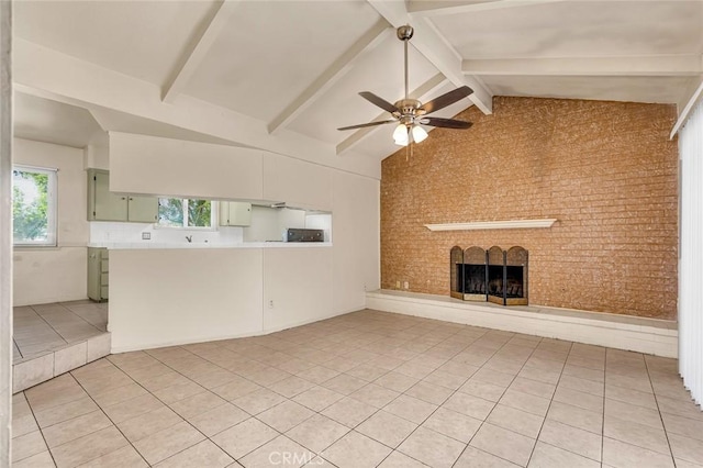 635 Brookdale Dr, Merced, CA 95340 - unfurnished living room with light tile patterned flooring, a ceiling fan, a brick fireplace, brick wall, and beam ceiling