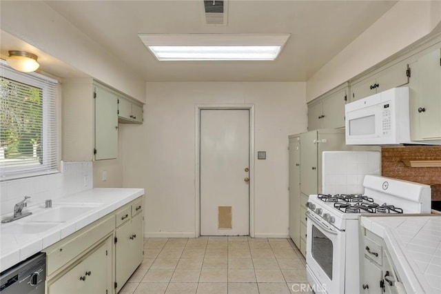 635 Brookdale Dr, Merced, CA 95340 - kitchen with white appliances, tile counters, a sink, and backsplash