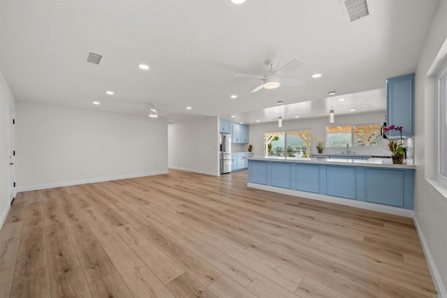12632 Mcferon Rd, Poway, CA 92064 - unfurnished living room with a ceiling fan, light wood finished floors, recessed lighting, baseboards, and a sink