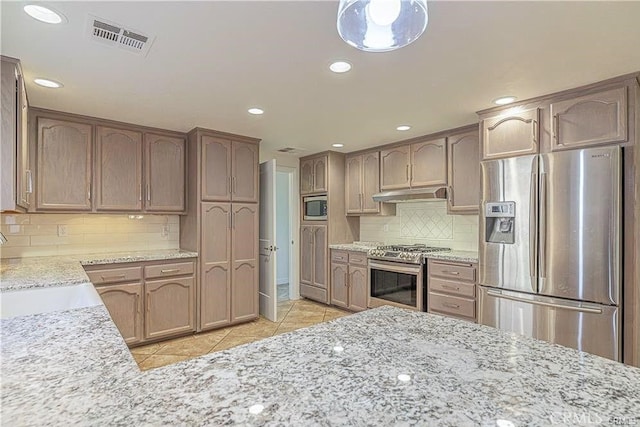 40052 18th St W, Palmdale, CA 93551 - kitchen with stainless steel appliances, under cabinet range hood, light tile patterned floors, backsplash, and recessed lighting
