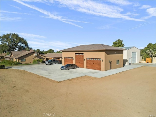40052 18th St W, Palmdale, CA 93551 - view of front of house featuring stucco siding, a detached garage, and dirt driveway