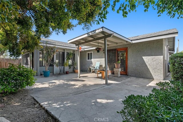 9945 Date St, Fontana, CA 92335 - back of house featuring stucco siding and a patio