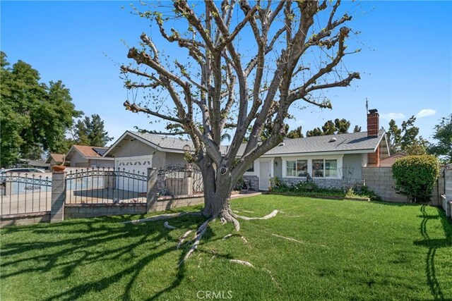 9945 Date St, Fontana, CA 92335 - view of front of home featuring a chimney and an attached garage