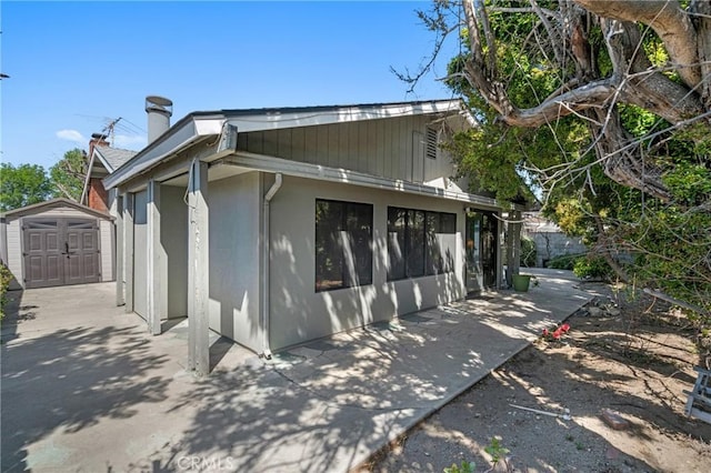 9945 Date St, Fontana, CA 92335 - view of side of home with a patio area and a chimney