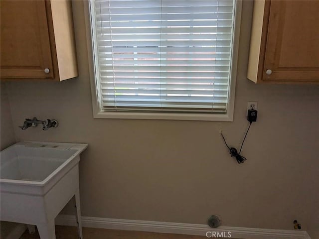12707 Hoback St, Norwalk, CA 90650 - laundry room featuring washer hookup, cabinet space, and baseboards