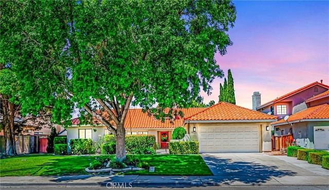 42635 56th St W, Lancaster, CA 93536 - view of front of home featuring a tile roof, an attached garage, driveway, and stucco siding