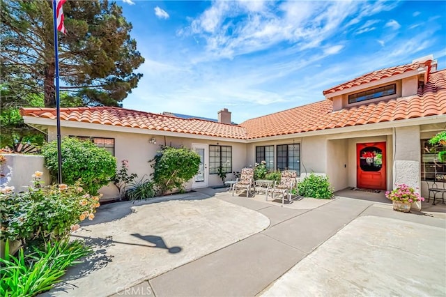 42635 56th St W, Lancaster, CA 93536 - mediterranean / spanish home featuring a tiled roof, stucco siding, and a patio area