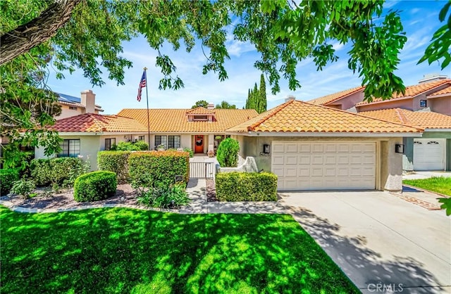 42635 56th St W, Lancaster, CA 93536 - view of front of property with an attached garage, stucco siding, a tile roof, driveway, and a front lawn