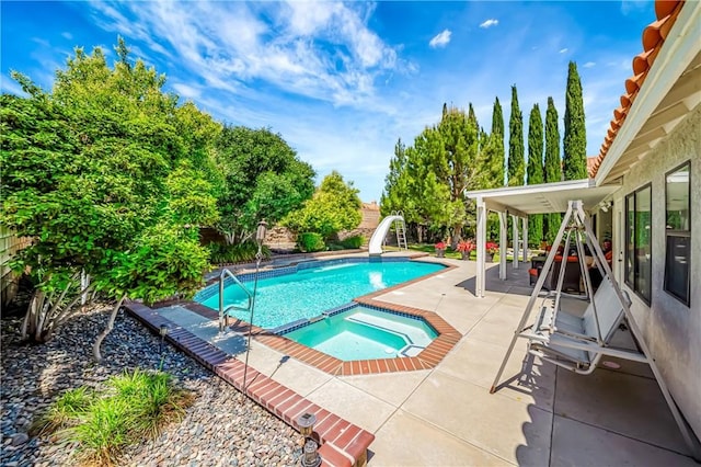 42635 56th St W, Lancaster, CA 93536 - view of pool featuring a water slide, a patio, a fenced backyard, and a pool with connected hot tub