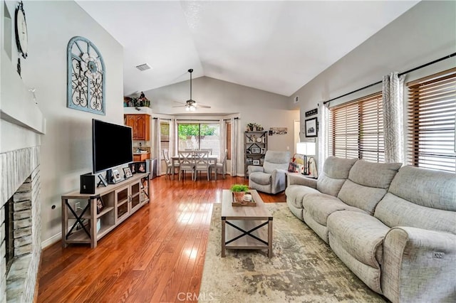 42635 56th St W, Lancaster, CA 93536 - living area with a fireplace, vaulted ceiling, ceiling fan, and hardwood / wood-style floors