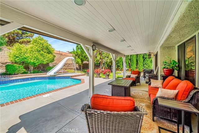 42635 56th St W, Lancaster, CA 93536 - swimming pool with a water slide, a fenced backyard, a patio, and outdoor lounge area