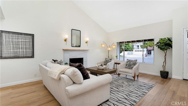 15061 Glass Cir, Irvine, CA 92604 - living room with light wood-style flooring, a fireplace, baseboards, and high vaulted ceiling