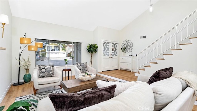 15061 Glass Cir, Irvine, CA 92604 - living area featuring wood finished floors, stairway, and high vaulted ceiling