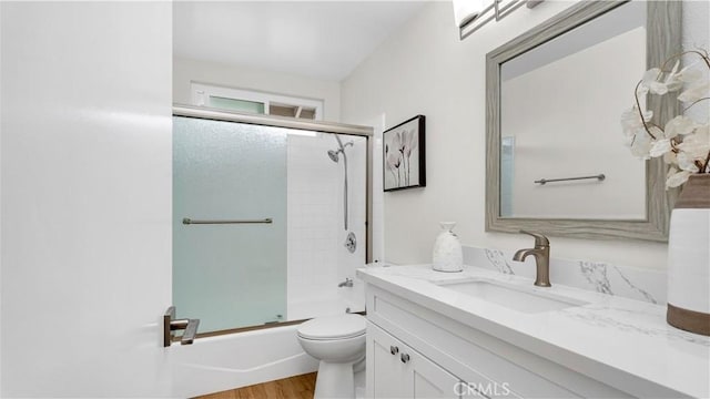 15061 Glass Cir, Irvine, CA 92604 - full bathroom with vanity, toilet, bath / shower combo with glass door, and wood finished floors