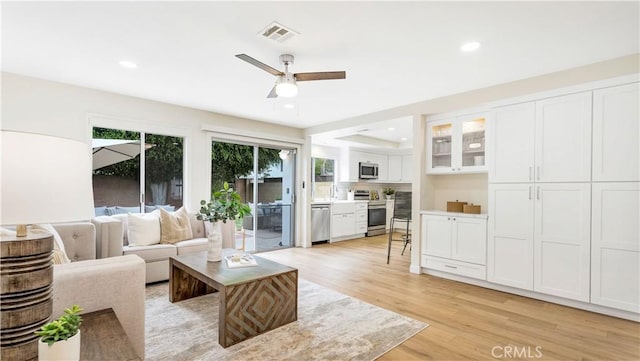 15061 Glass Cir, Irvine, CA 92604 - living room featuring light wood-style floors, ceiling fan, and recessed lighting