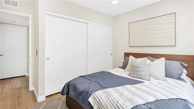 15061 Glass Cir, Irvine, CA 92604 - bedroom featuring a closet, wood finished floors, baseboards, and recessed lighting