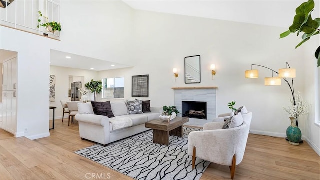 15061 Glass Cir, Irvine, CA 92604 - living room with light wood finished floors, a fireplace, baseboards, and recessed lighting