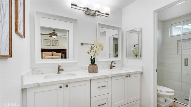 15061 Glass Cir, Irvine, CA 92604 - full bath with double vanity, toilet, a stall shower, and a ceiling fan