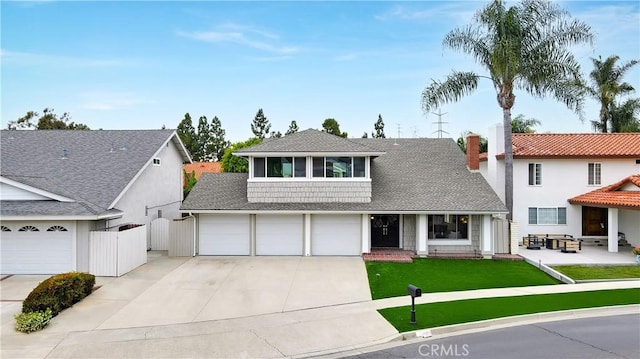 15061 Glass Cir, Irvine, CA 92604 - view of front facade with driveway, roof with shingles, a garage, and a chimney