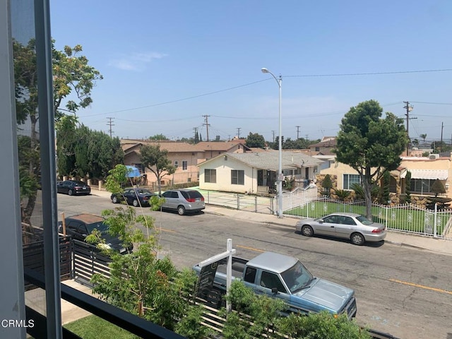 729 S Kern Ave, Los Angeles, CA 90022 - view of asphalt street with street lighting, a residential view, sidewalks, and curbs